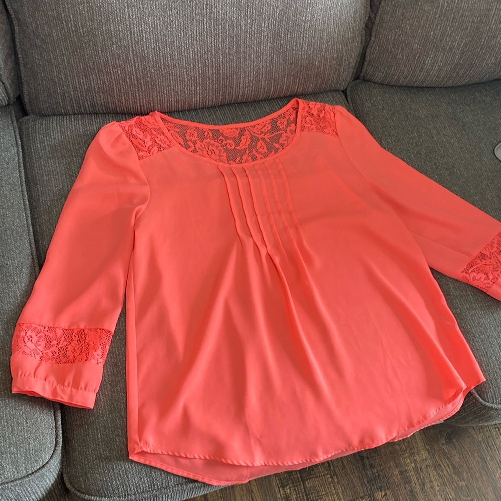 cute vibrant coral colored blouse. cute see through wrists and top.